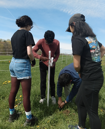 Students members of CU GeoData take soil moisture measurements