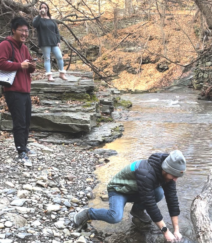 Students taking a water sample from Cascadilla Creek