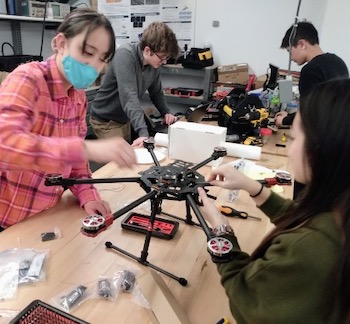 CU GeoData student members work on a drone they are building to use in measurements of the local topography